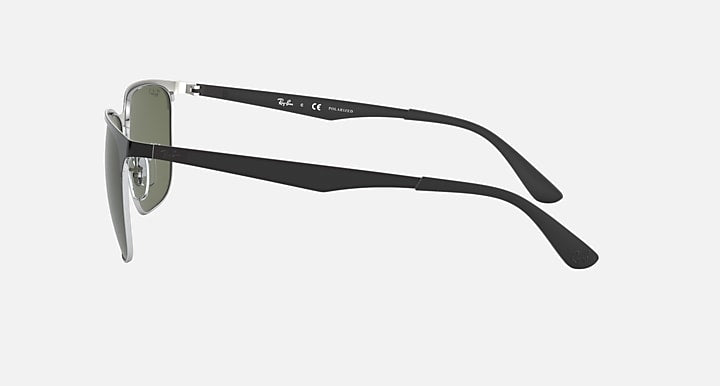 Sunglasses in black with dark green lenses, side profile and curved temple tips