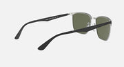 Sunglasses with green lenses and silver frame in angled side view; visible temple logo
