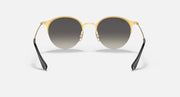 RB3578 sunglasses with gold frame, black temples, and dark tinted round lenses.