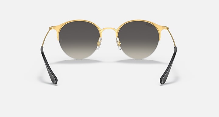 RB3578 sunglasses with gold frame, black temples, and dark tinted round lenses.
