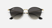 RB3578 sunglasses with black temples, gold rims, and dark tinted round lenses.