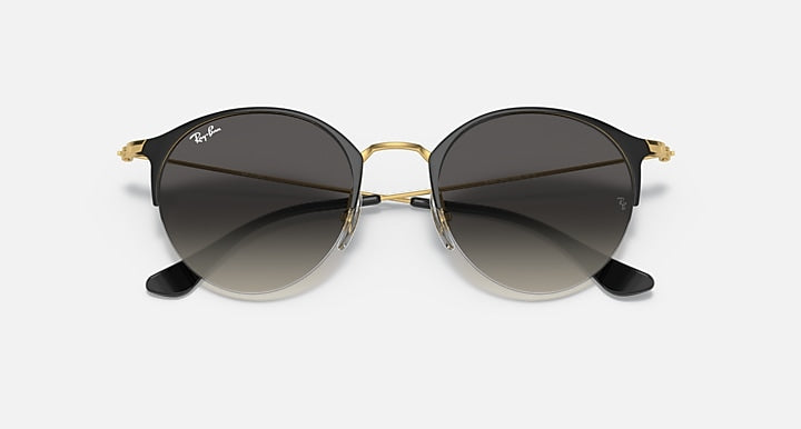 RB3578 sunglasses with black temples, gold rims, and dark tinted round lenses.