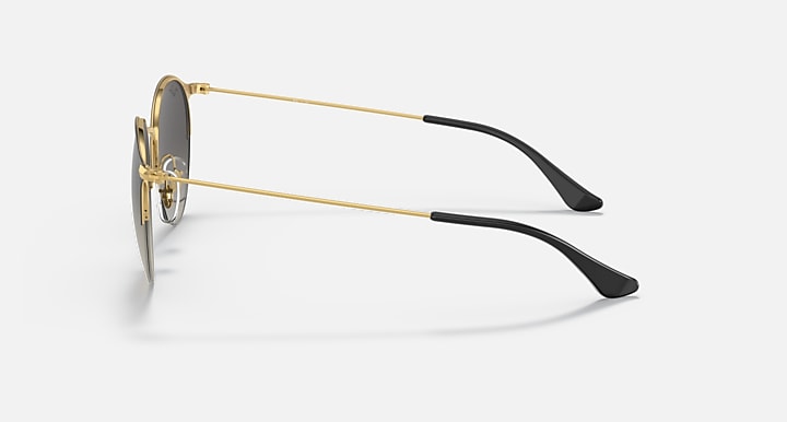 RB3578 sunglasses side view with gold metal arms and dark lenses.