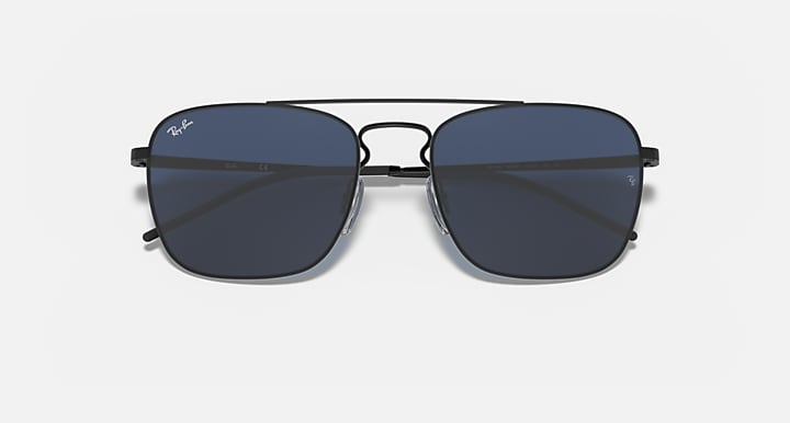 Narrow rectangular sunglasses with dark blue lenses and black metal frame, logo marks