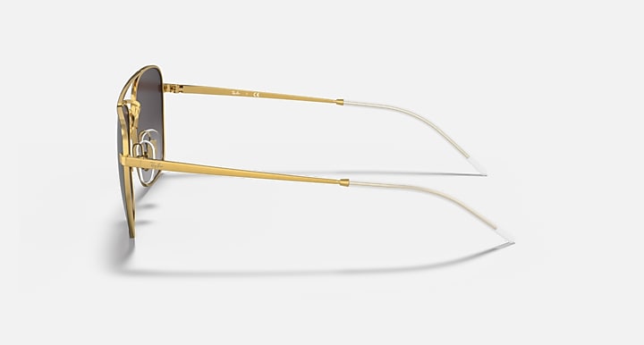 Side view of gold sunglasses frame with thin clear temples