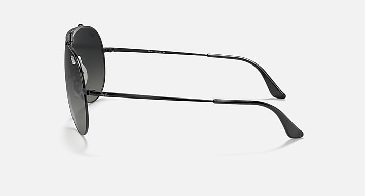 Aviator-style sunglasses with black frames and dark smoke lenses, side view