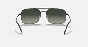 Front-facing sunglasses with dark green lenses and black metal frame, nose bridge visible