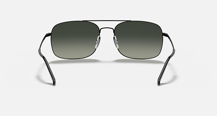 Front-facing sunglasses with dark green lenses and black metal frame, nose bridge visible