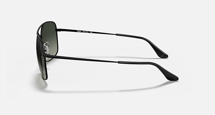 Side-profile sunglasses with dark green lenses and black metal frame with thin arms