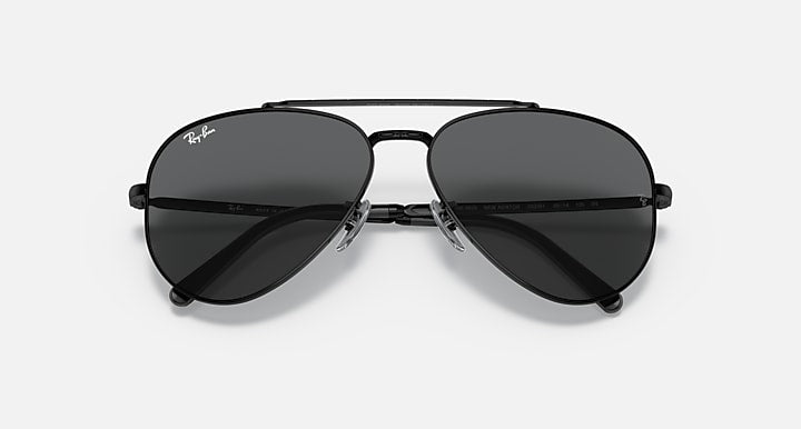 Aviator sunglasses with black frame and dark lenses, close front view.
