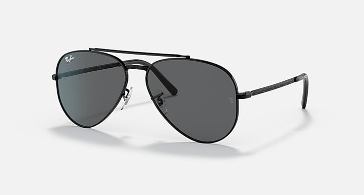 Aviator sunglasses with gold-tone metal frame and blue-tinted dark lenses, angled view.