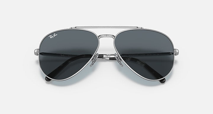 Aviator sunglasses with silver-tone metal frame and dark lenses, close front view.