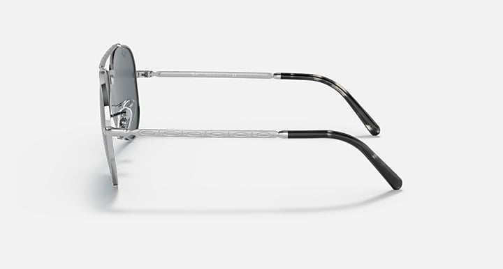 Aviator sunglasses with silver-tone metal frame and dark lenses, side profile.