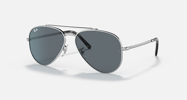Aviator sunglasses with gold-tone metal frame and blue-tinted dark lenses, angled view.