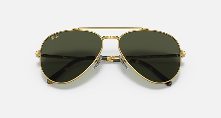 Gold-tone aviator sunglasses with dark green lenses; front view with metal bridge
