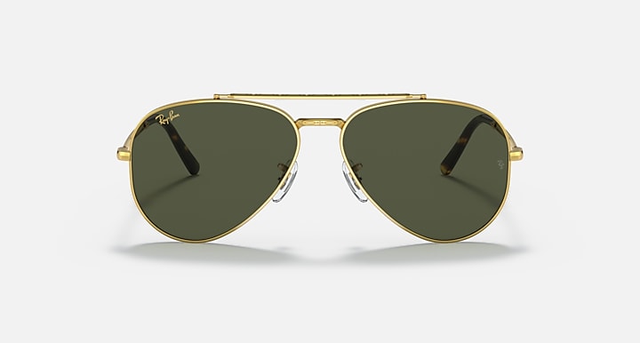 Gold-tone aviator sunglasses with dark green lenses and signature cutout bridge