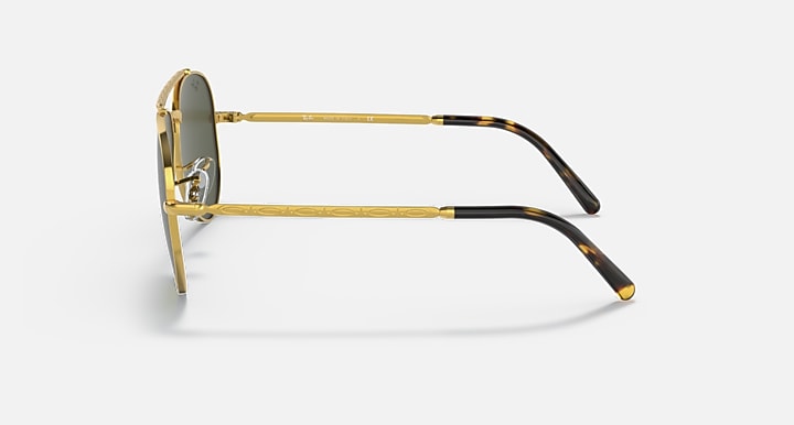 Gold-tone aviator sunglasses with green lenses; side view with tortoise temple accents