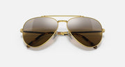 Aviator sunglasses with gold frame and dark mirrored lenses; slim metal bridge