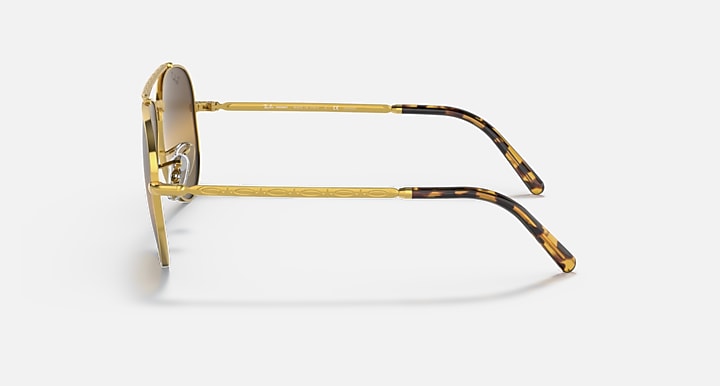 Aviator sunglasses with gold frame and tortoiseshell-pattern temples; side profile
