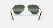 Aviator sunglasses with gold frame and dark green gradient lenses; tortoiseshell temple tips