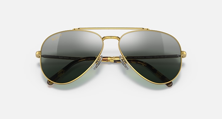 Aviator sunglasses with gold frame and dark green mirrored lenses; symmetrical front view