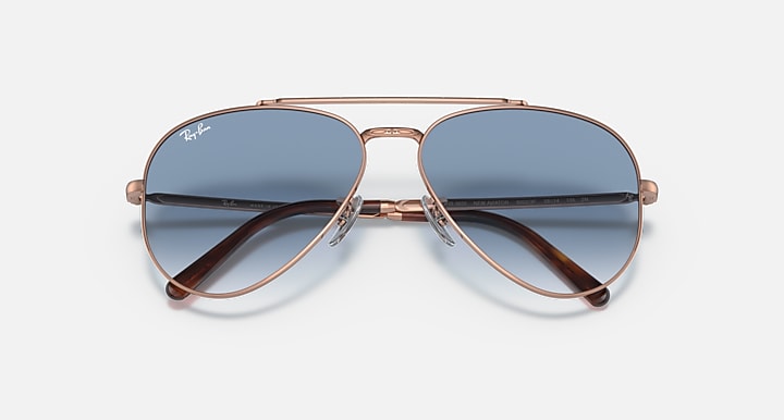 Rose gold aviator sunglasses with blue gradient lenses, front view with bridge detail