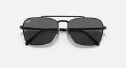 Black sunglasses with dark smoke lenses and a sculpted bridge between lenses
