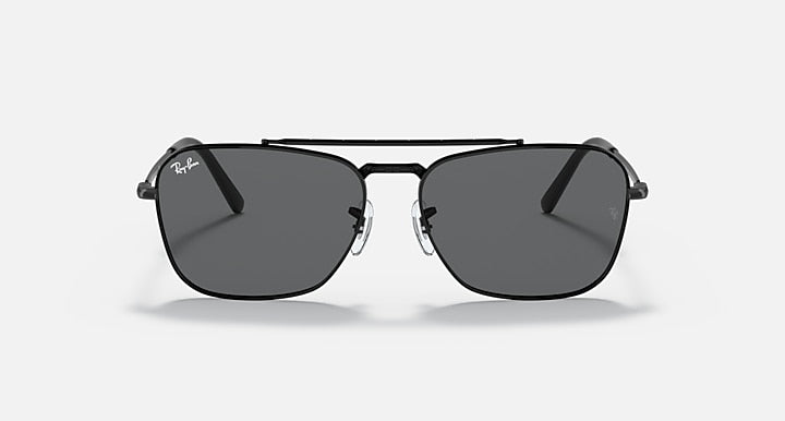 Black full-rim sunglasses with dark grey lenses and small logo on the temple