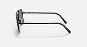 Black sunglasses shown from the side with curved metal arms and dark lens