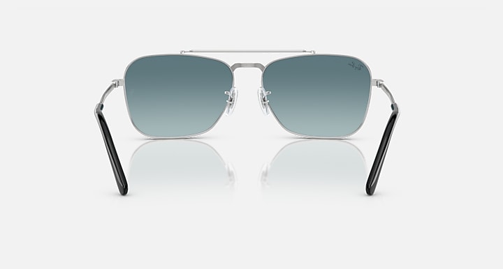 Ray-Ban Caravan sunglasses with silver frame, dark teal lenses, and black temple tips