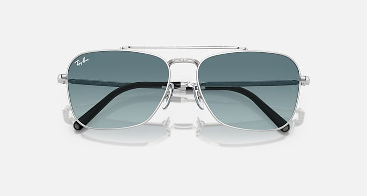 Ray-Ban Caravan sunglasses angled view with silver frame and dark teal mirrored lenses