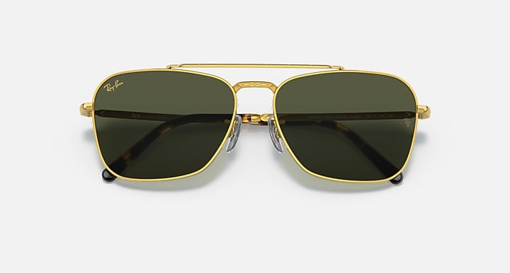 Gold sunglasses with black-tinted lenses and a dual-bridge front design