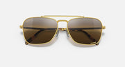 Caravan-style sunglasses with gold frame and black gradient lenses, front view