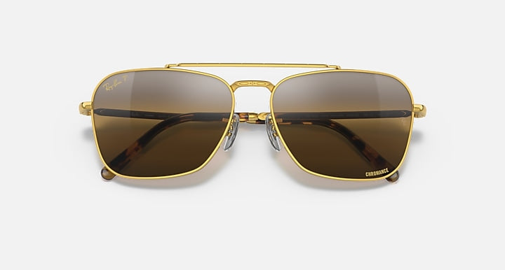 Caravan-style sunglasses with gold frame and black gradient lenses, front view