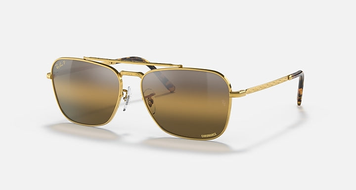 Caravan-style sunglasses with gold frame and dark brown gradient lenses