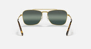 Caravan-style sunglasses with gold frame and dark green rectangular lenses, front view