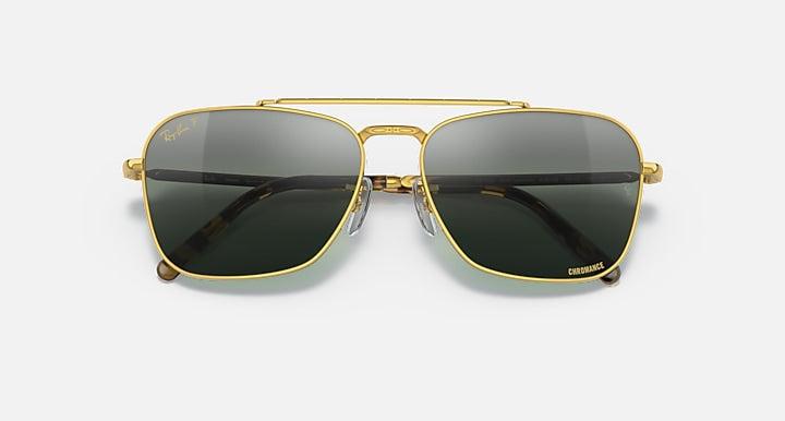 Caravan-style sunglasses with gold frame and black gradient lenses, centered front view