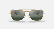 Caravan-style sunglasses with gold frame and dark green gradient lenses, front view