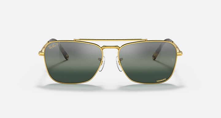 Caravan-style sunglasses with gold frame and dark green gradient lenses, front view