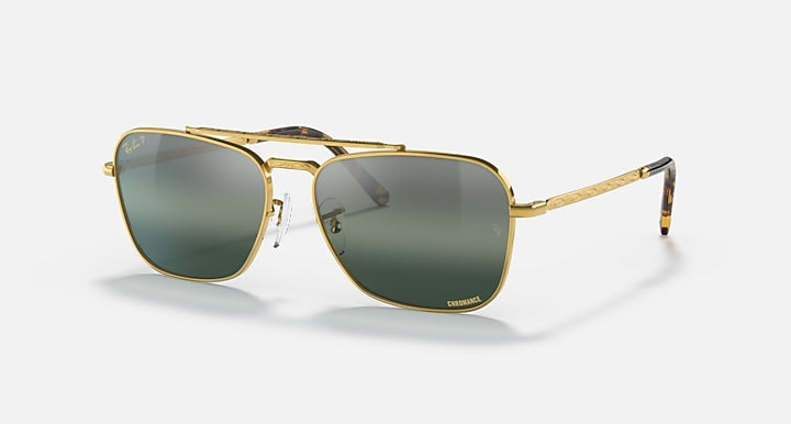 Caravan-style sunglasses with gold frame and dark green gradient lenses, side angle