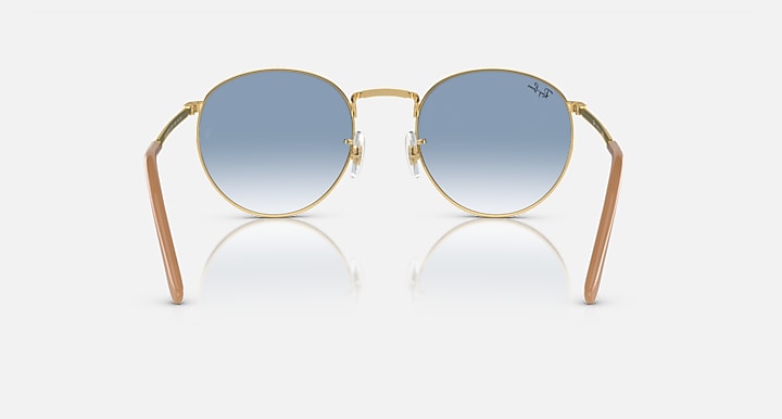 Gold-tone round sunglasses with blue gradient lenses, front view and symmetrical arms