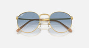 Gold-tone round sunglasses with blue gradient lenses and wide angular brow bar