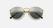 Round gold metal sunglasses with dark tinted lenses and patterned temple arms