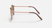 Ray-Ban round sunglasses side view with rose-gold frame and brown-tinted arms