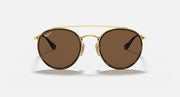 Round sunglasses with gold metal frame and dark brown gradient lenses, double bridge.