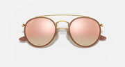 Round sunglasses with gold metal frame and rose pink lenses, double bridge and nose bridge cutout.