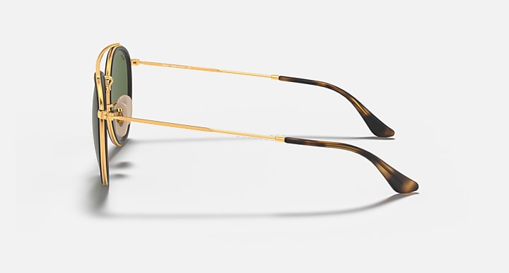 Ray-Ban double-bridge sunglasses, side view with gold frame and brown temples