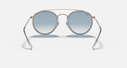 Rose-gold round sunglasses with blue mirrored lenses, front stand view