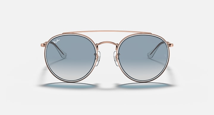Round metal sunglasses with rose-gold frame and blue mirrored lenses, front view