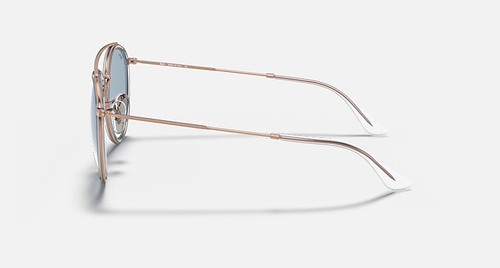 Rose-gold metal sunglasses with round lenses, side profile with slim arms